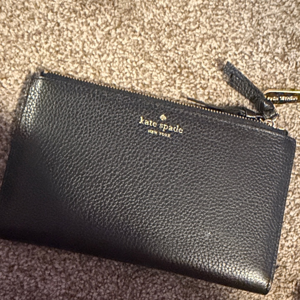 kate spade black pebbled leather wristlet with gold logo